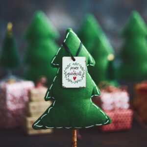 Christmas Background with Tiny Christmas Trees and Message of Peace and Goodwill
