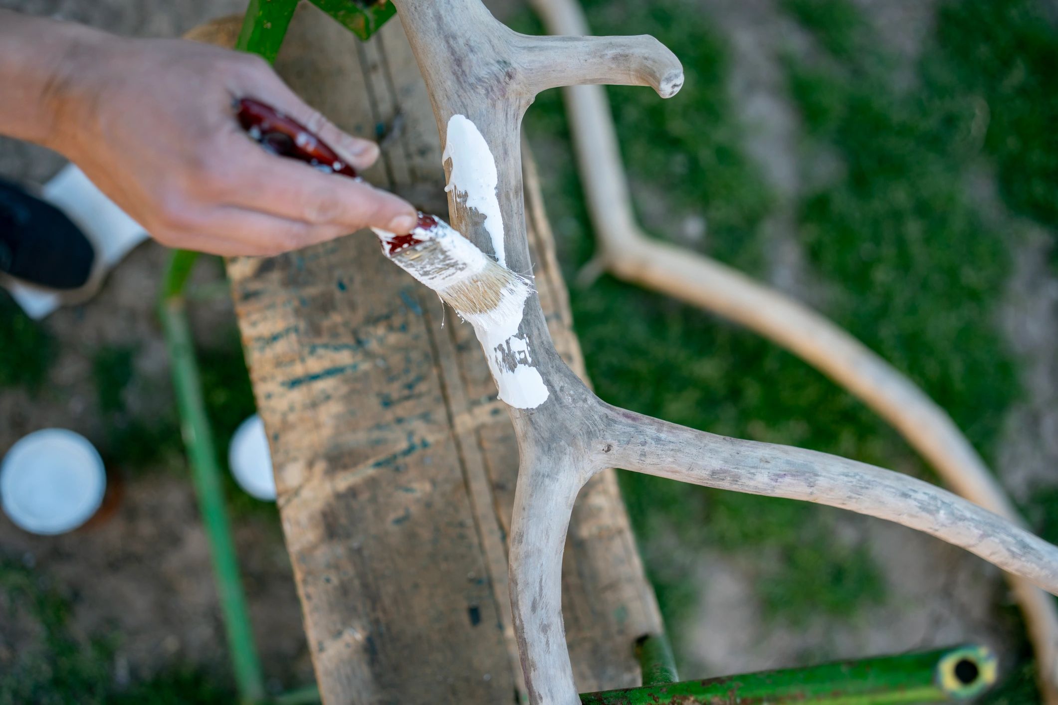 Hand-painted craft project on a rustic workbench